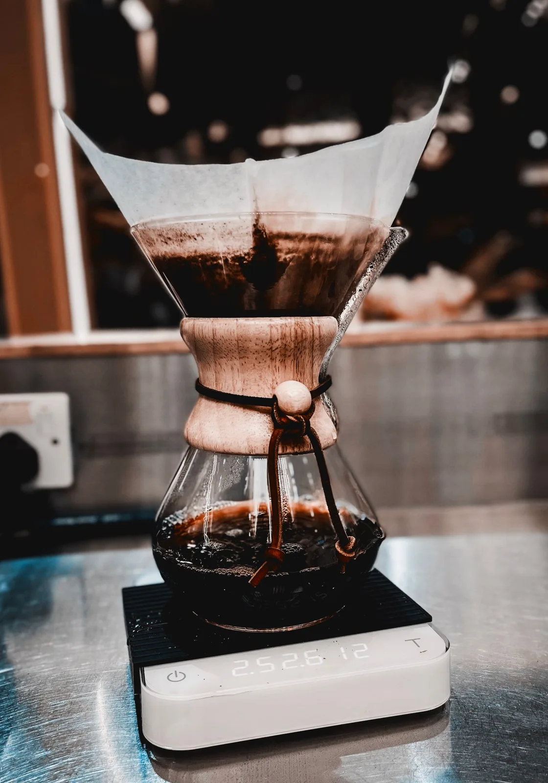Coffee equipment resting on a digital kitchen scale