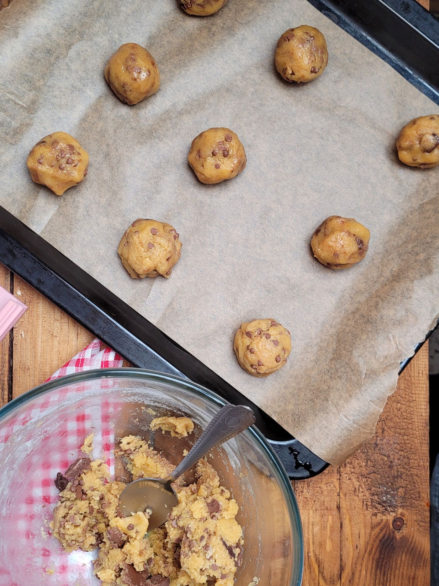 Cookie dough portions on a lined baking tray