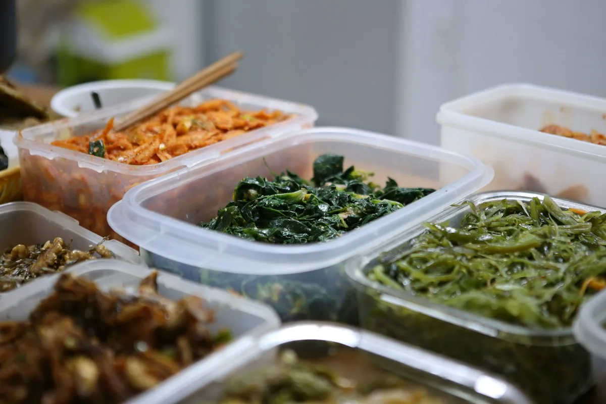 Several food containers filled with prepared vegetables