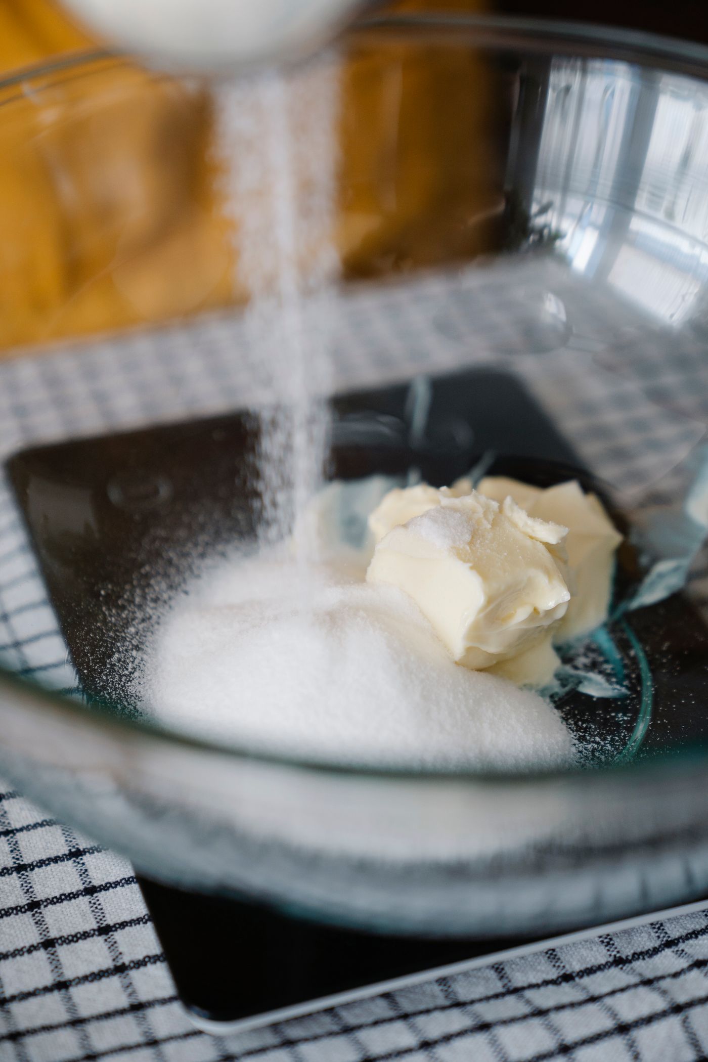 Sugar and butter in a glass mixing bowl