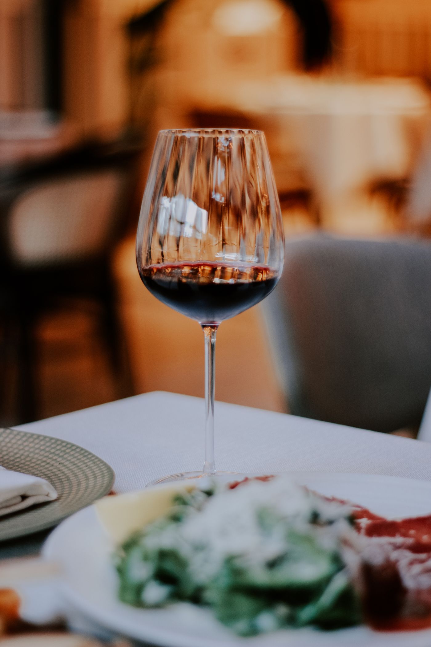 A glass of red wine on a restaurant table
