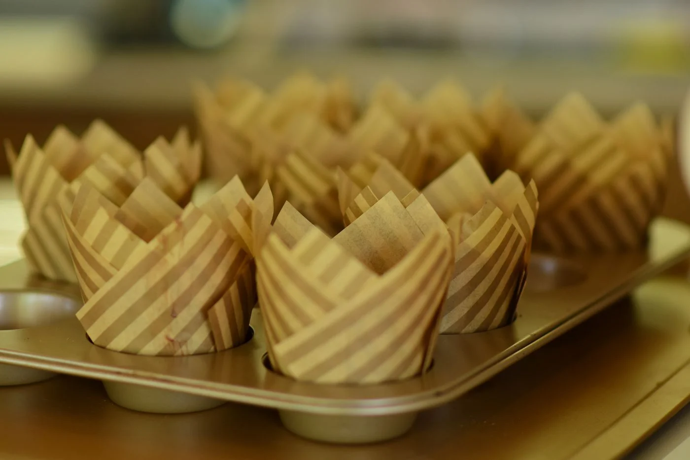 Striped paper muffin cups arranged inside a baking tray