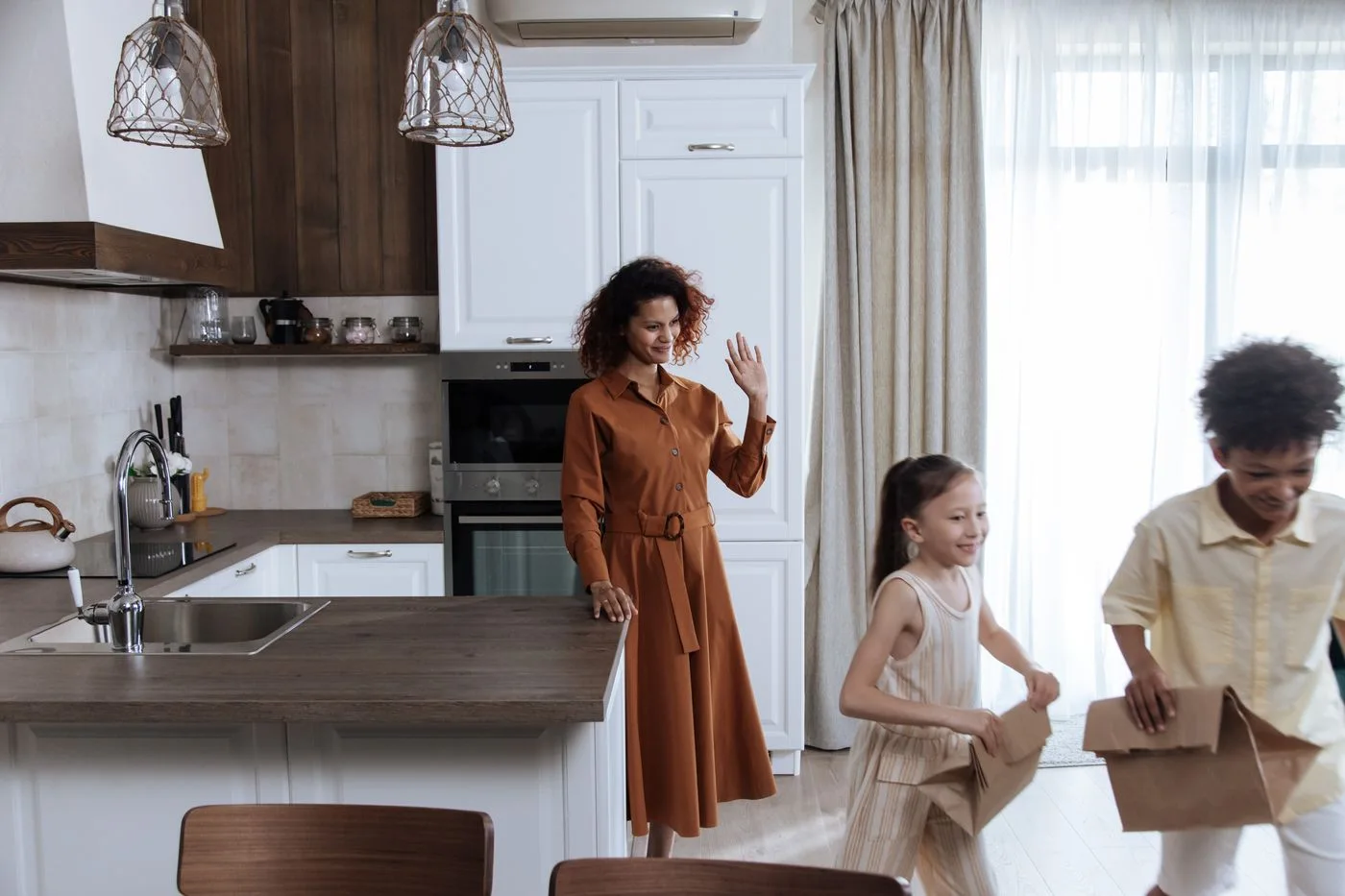 Adults and children standing together in a bright kitchen