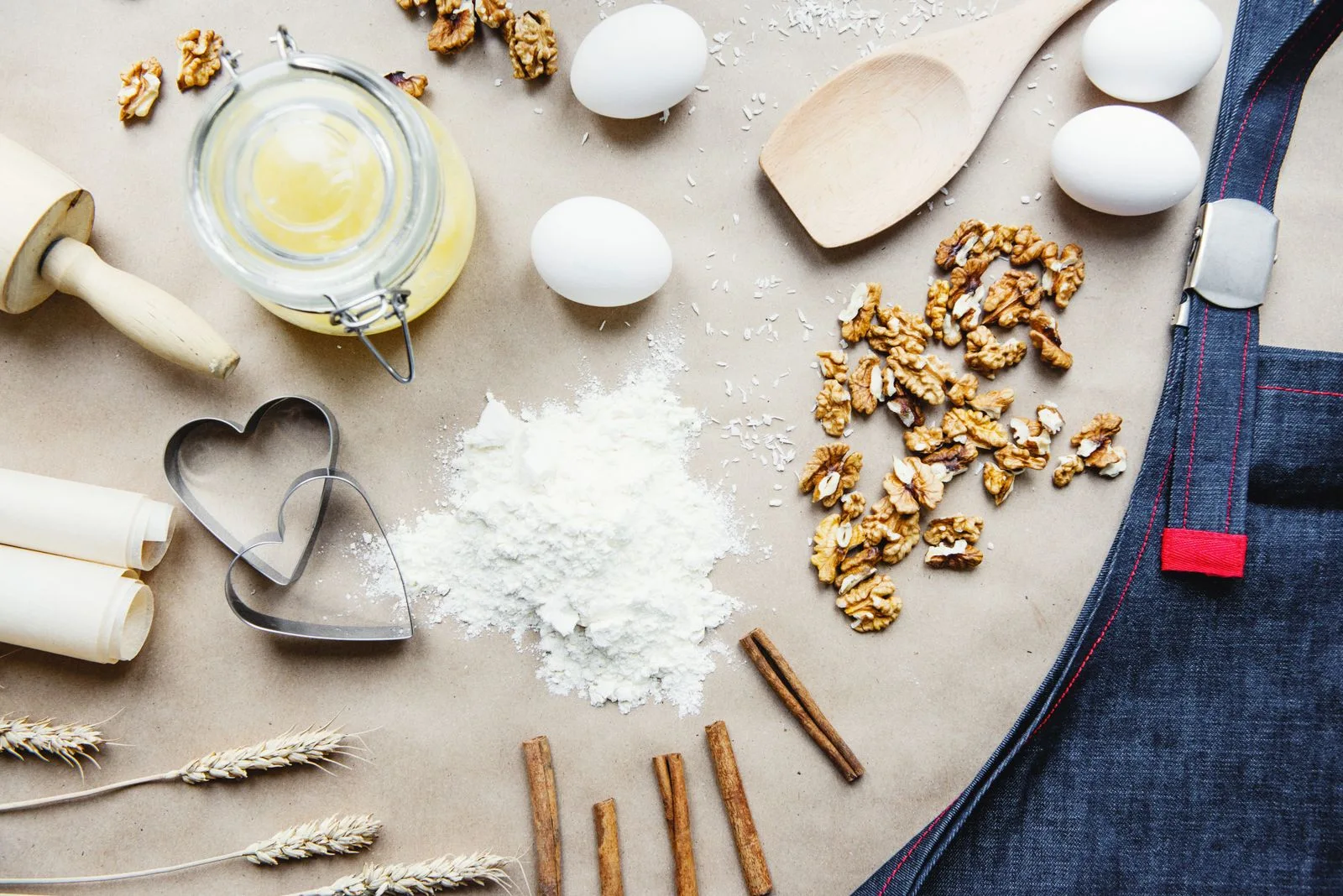 Flour, eggs and baking tools arranged on a work surface